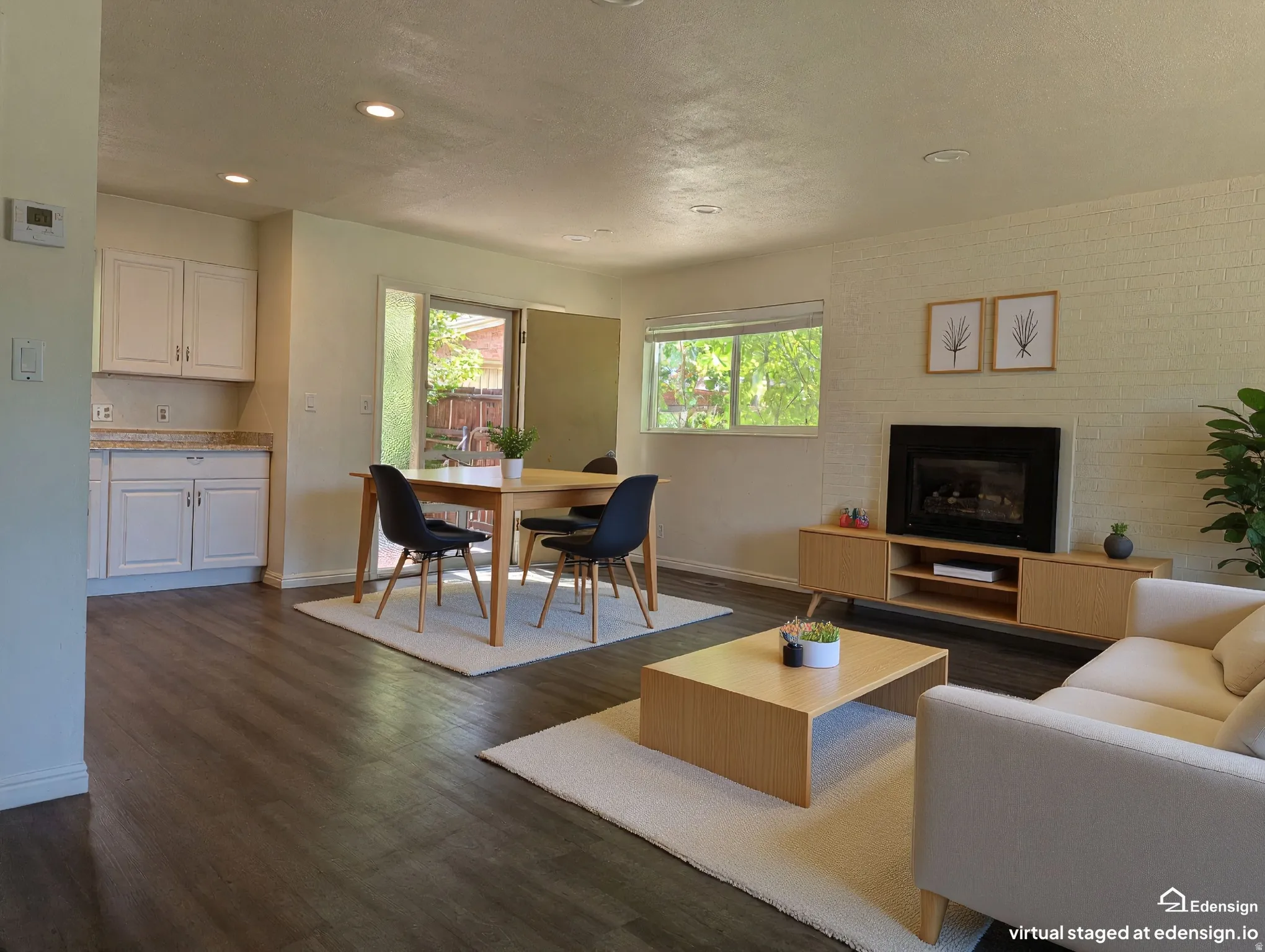 Virtually Staged. Living area featuring wood-finish flooring, recessed lighting, and a painted brick accent wall