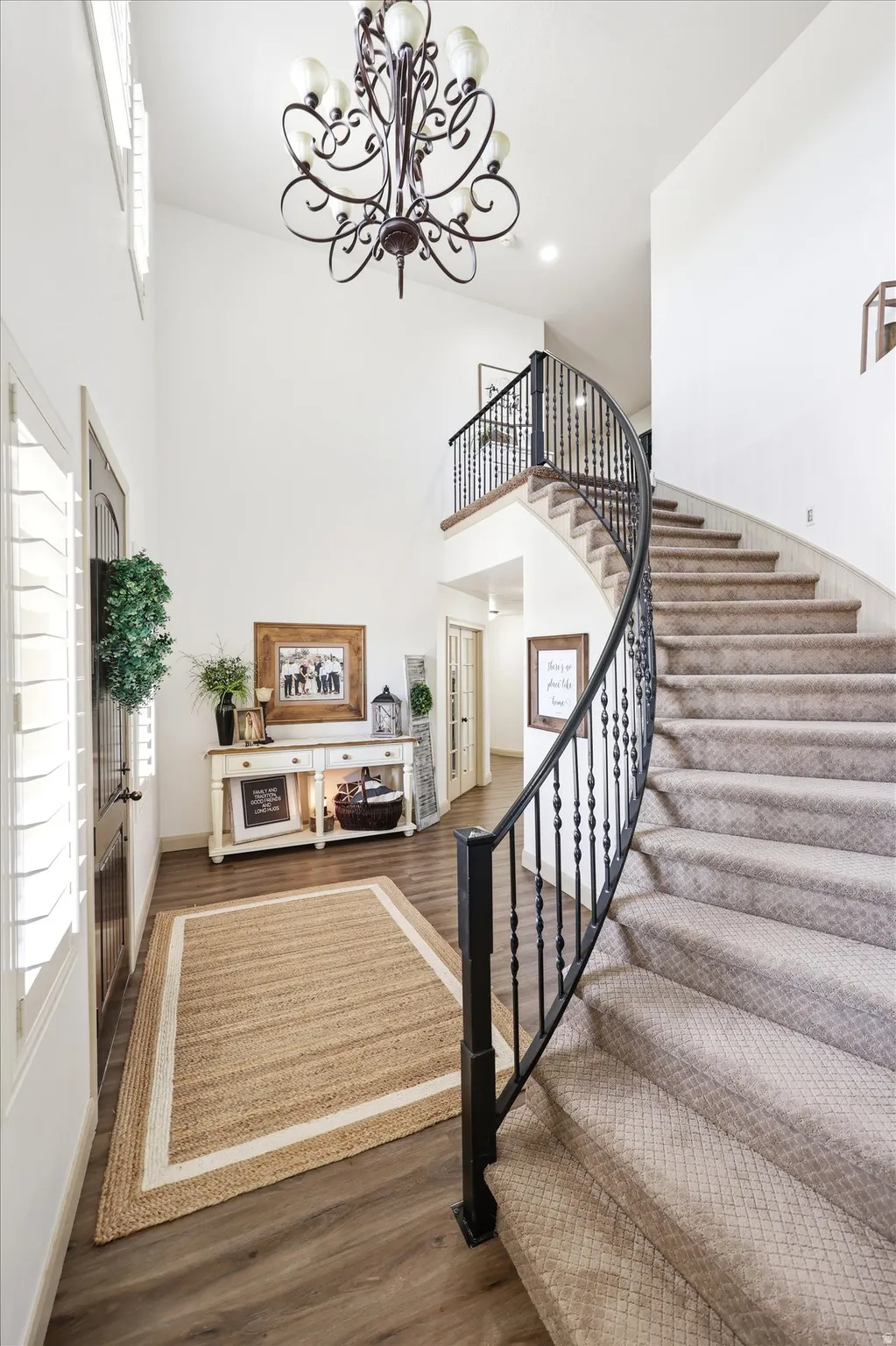 Grand foyer featuring a two-story ceiling and an ornate chandelier
