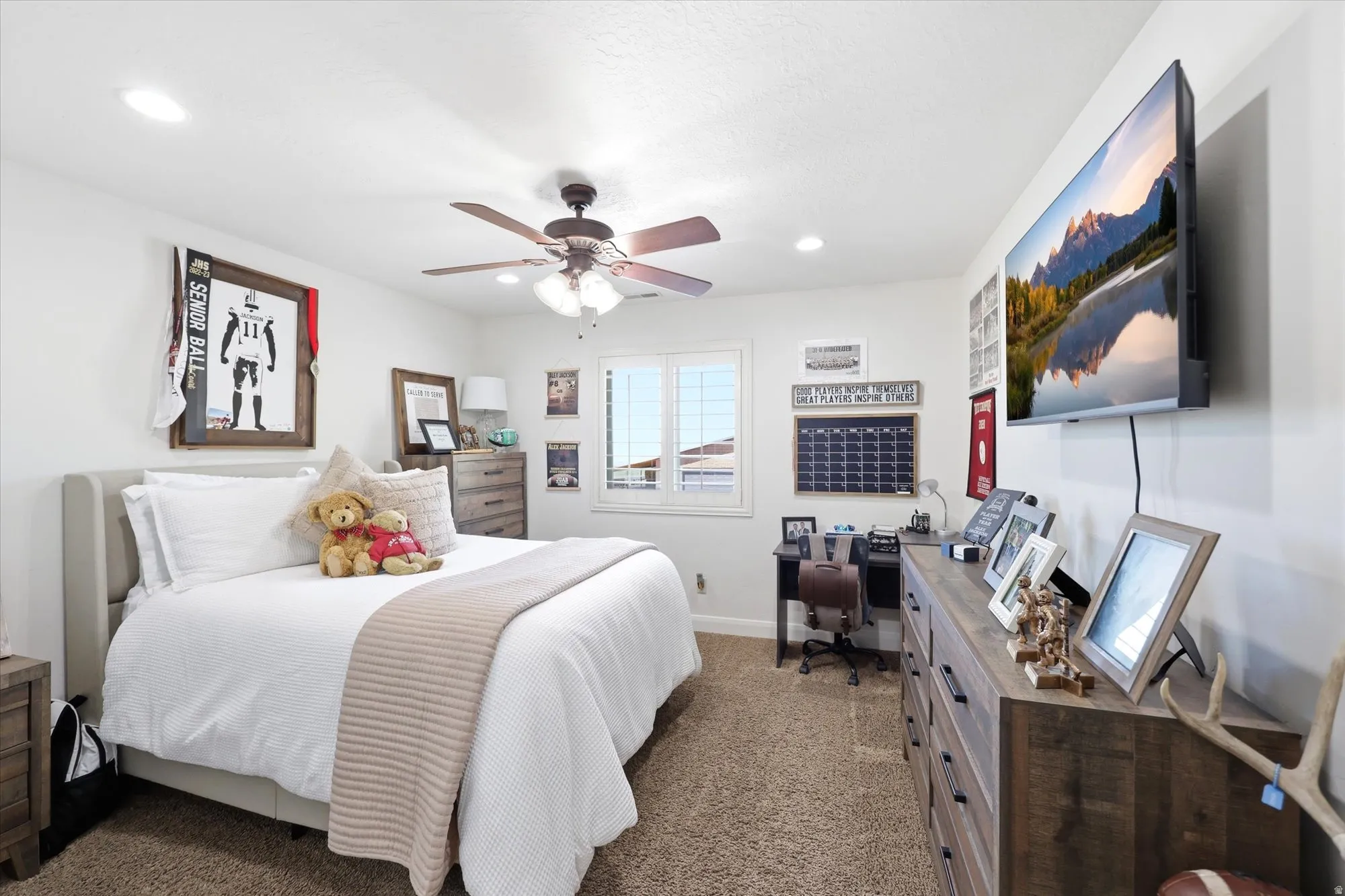 PRIMARY Bright bedroom featuring a ceiling fan with integrated lighting, recessed lighting, and a window with blinds