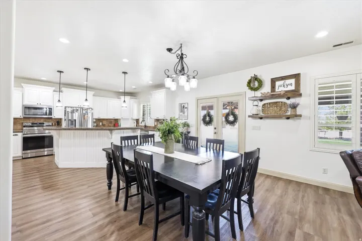 Open-concept kitchen and dining area featuring wood-finish flooring