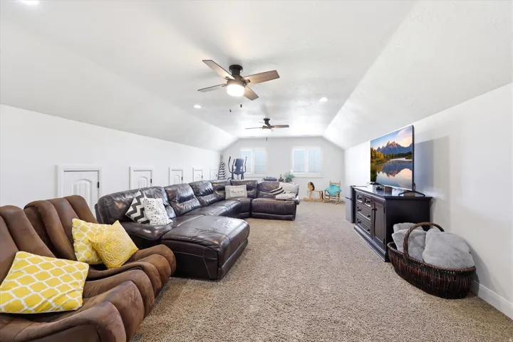 Spacious bonus room featuring vaulted ceilings, recessed lighting, and wall-to-wall carpeting