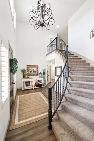 Grand foyer featuring a two-story ceiling and an ornate chandelier