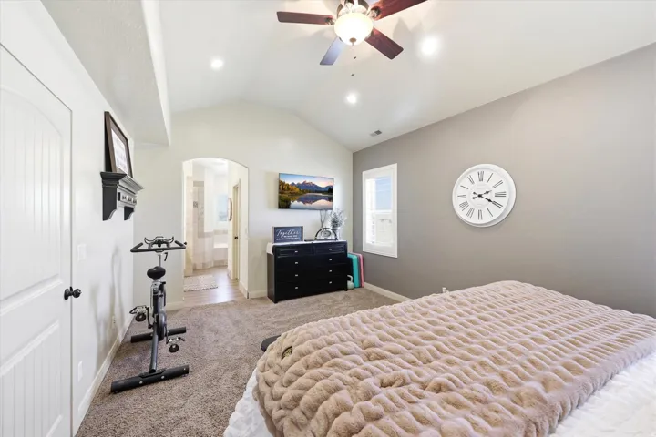 PRIMARY Vaulted ceiling bedroom featuring plush carpeting, recessed lighting, and a ceiling fan
