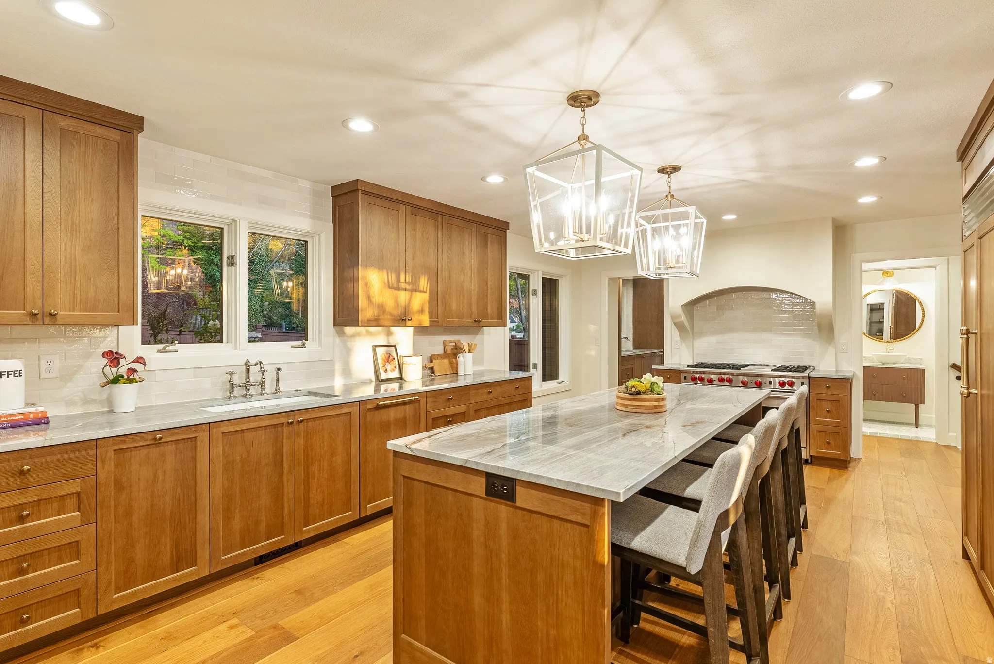 Gourmet kitchen featuring wood-finish cabinetry, light-toned countertops, and wide plank wood-finish flooring