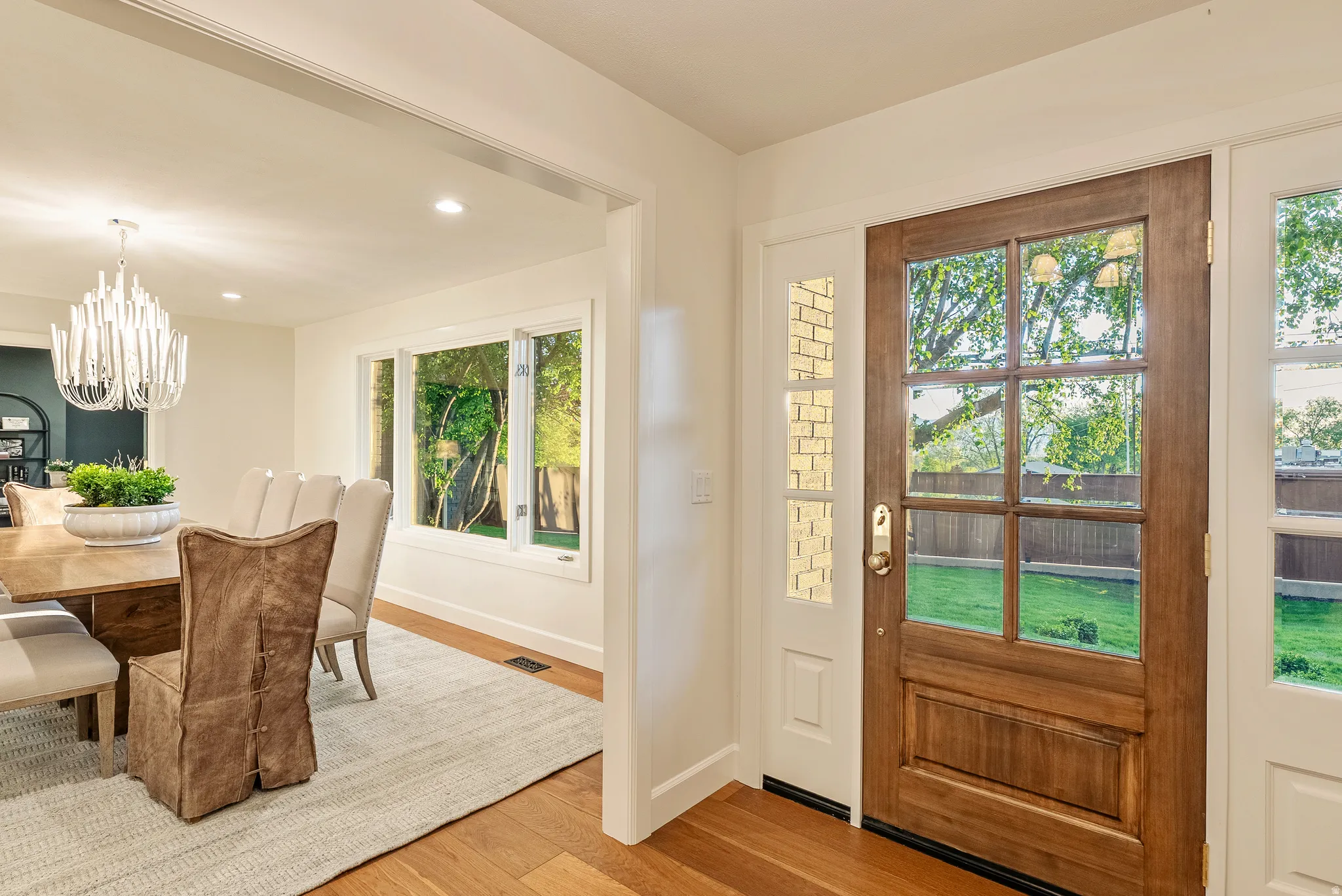Wood-finish entry door with clear glass panels and sidelites