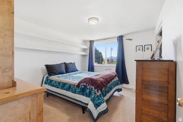 Bedroom featuring light-colored carpeting and white walls