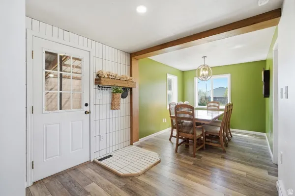 Entryway featuring wood-finish flooring and a white paneled door with grid-patterned glass