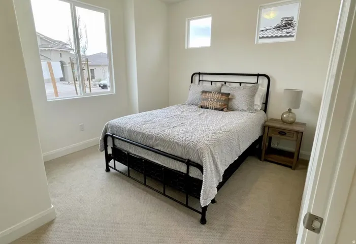 Bedroom featuring neutral-toned carpeting and light-colored walls