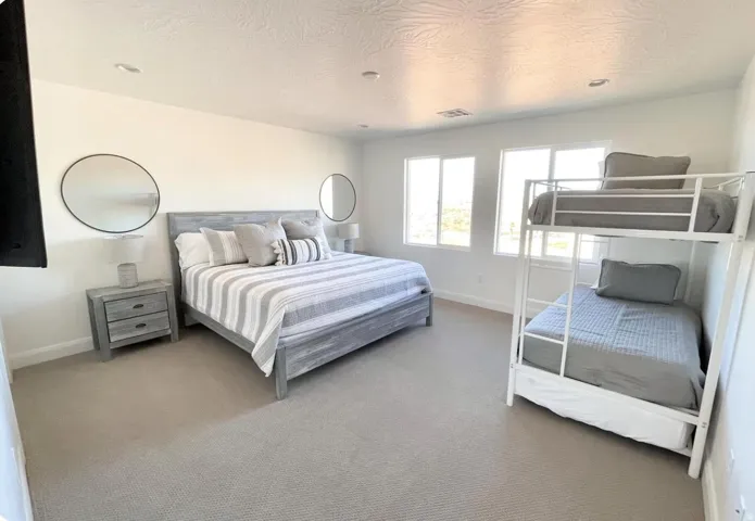 Spacious room featuring carpeting, multiple windows, and recessed lighting