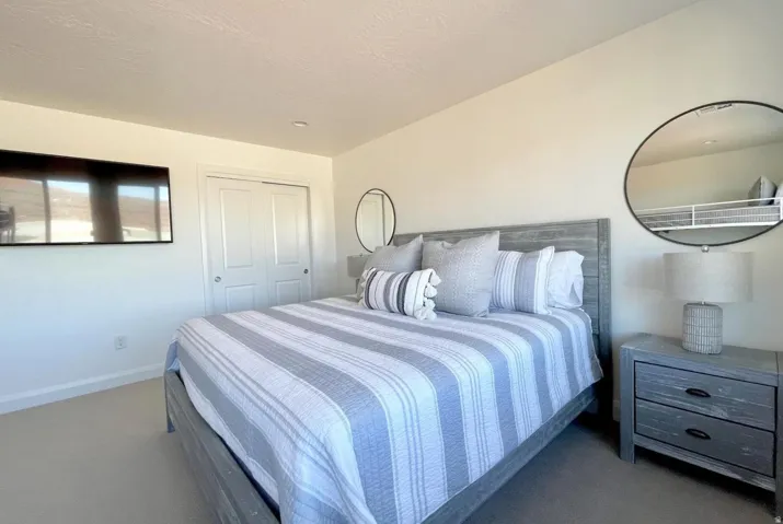 Bedroom featuring light-colored walls and soft carpet flooring