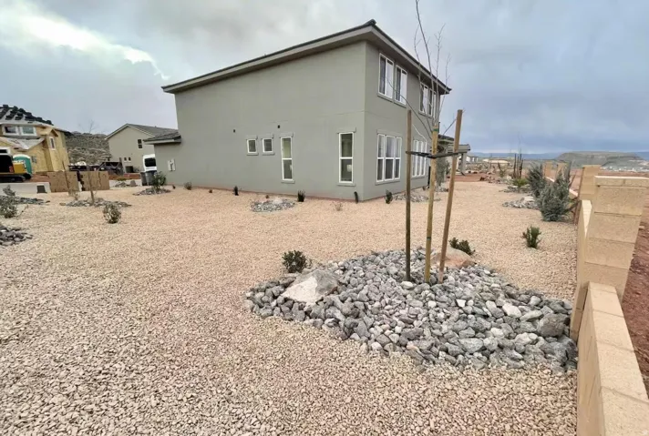 Contemporary exterior with light gray stucco siding and white-framed windows