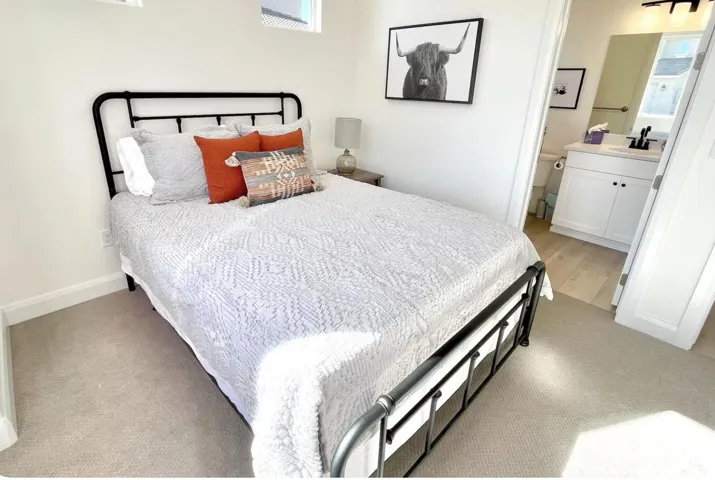 Bedroom featuring light-toned carpeting and a wide doorway