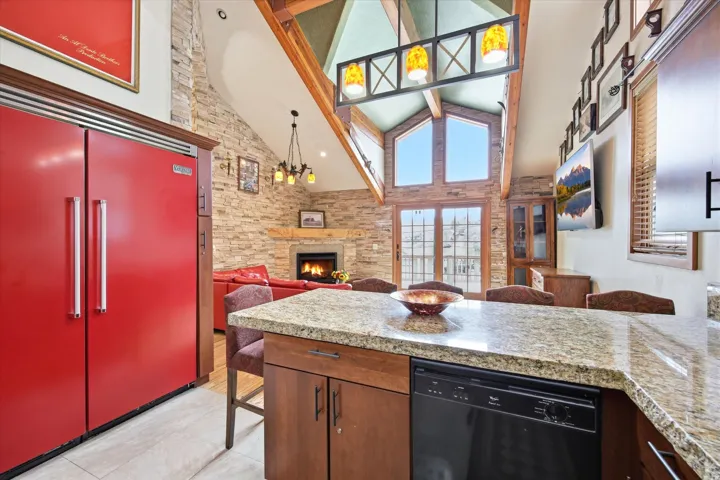 Expansive open-concept living area featuring a large kitchen island with granite-finish countertop.