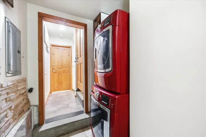 Dedicated laundry area featuring stacked front-load units