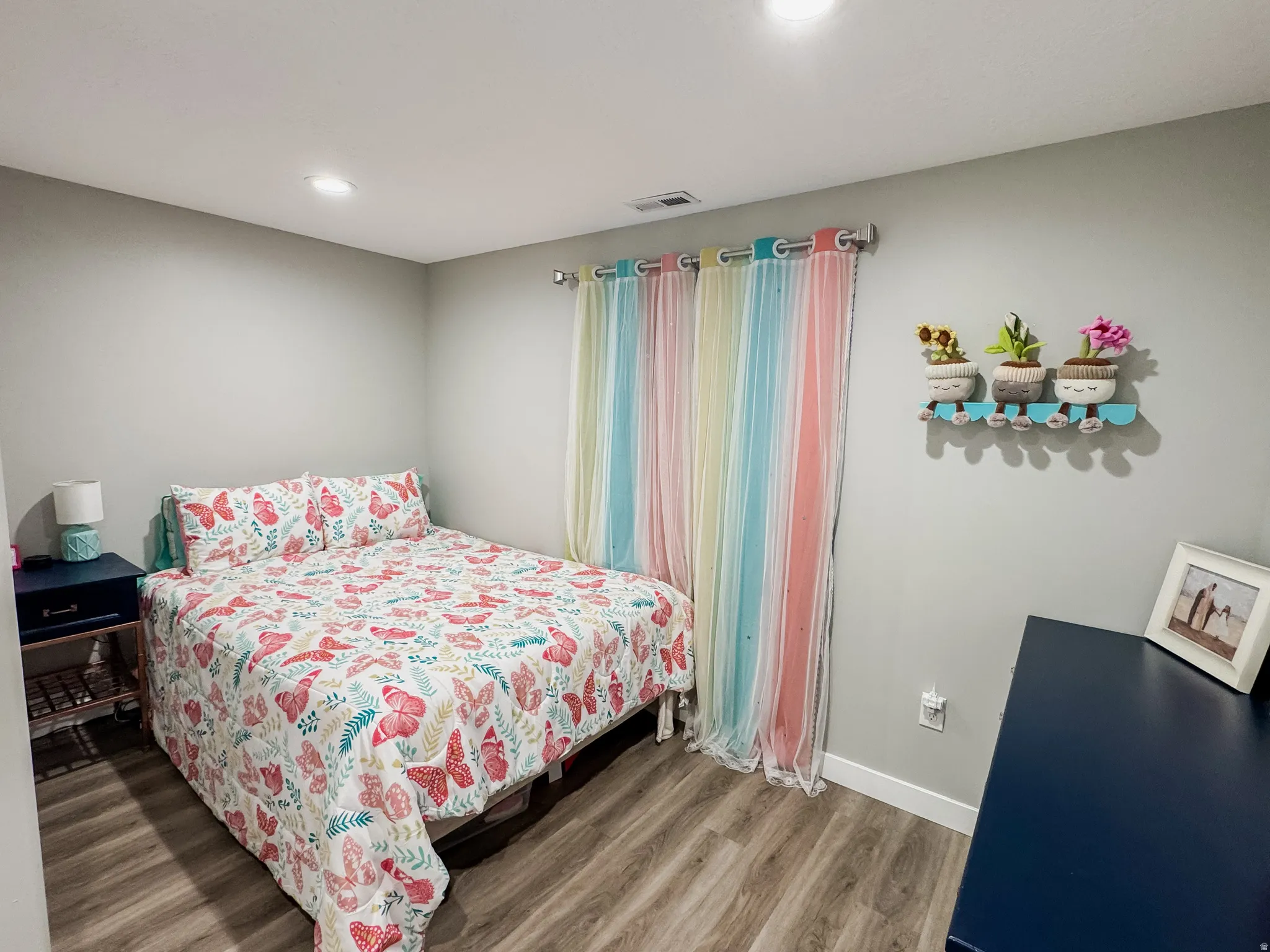 Interior room featuring wood-finish flooring, light gray walls, and recessed lighting