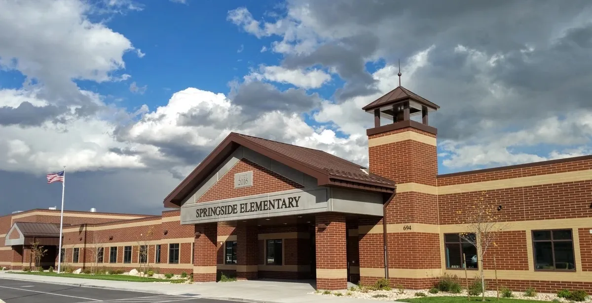 Red brick facade with a prominent gabled entry featuring a "Springside Elementary" sign
