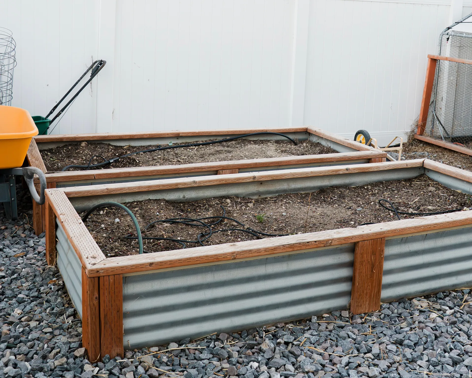 Two raised garden beds featuring corrugated metal and wood-finish framing