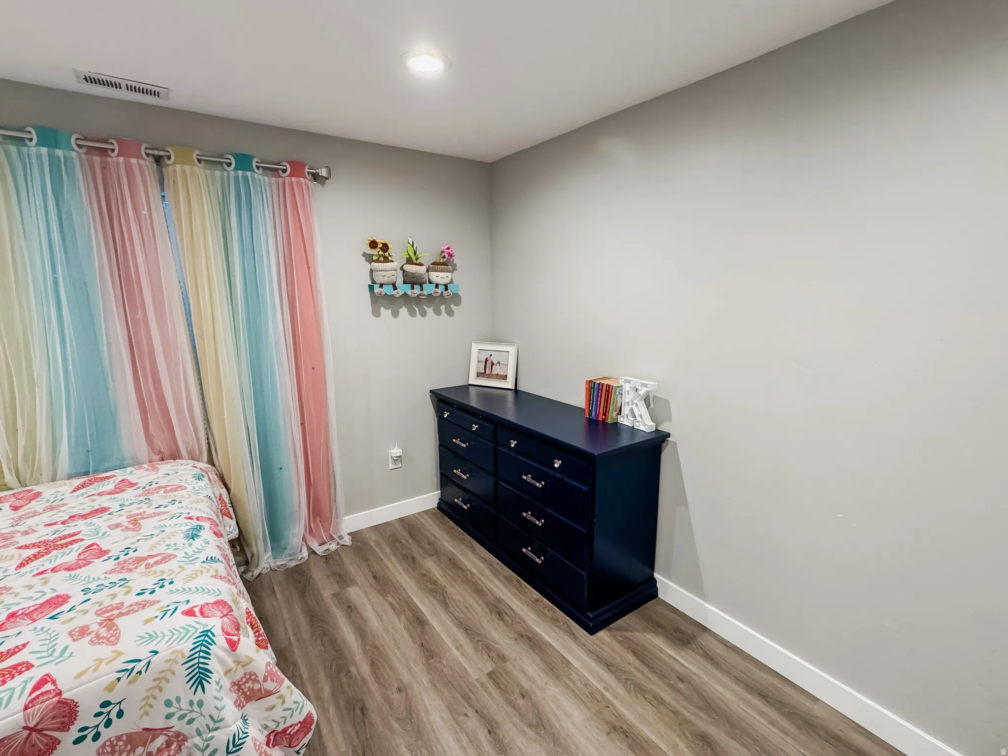 Warm gray walls complement the wood-finish flooring