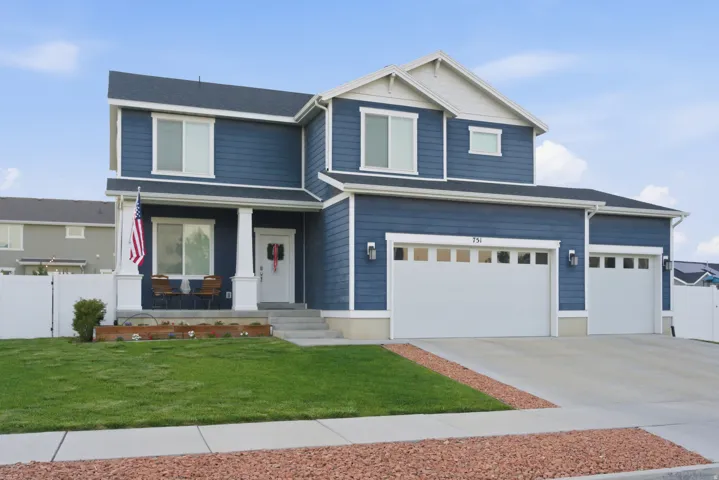 Two-story residence featuring blue siding and white trim accents