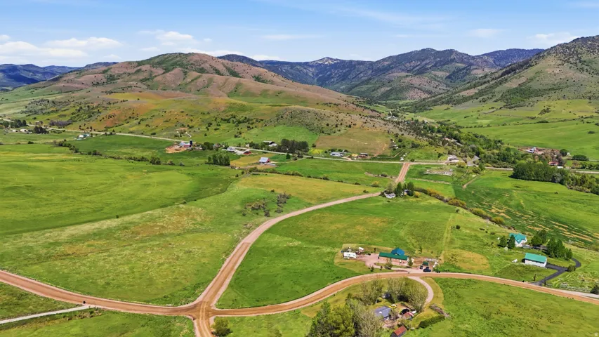 Expansive green landscape featuring rolling hills and distant mountains