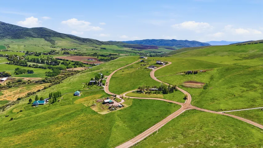 Expansive green landscape with rolling hills and distant mountains