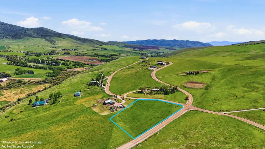 Expansive green parcel with a gentle slope and partial perimeter outlined in blue-for visual only