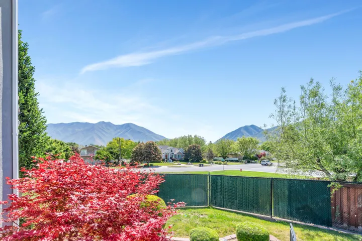 Landscaped yard with vibrant red foliage and green lawn