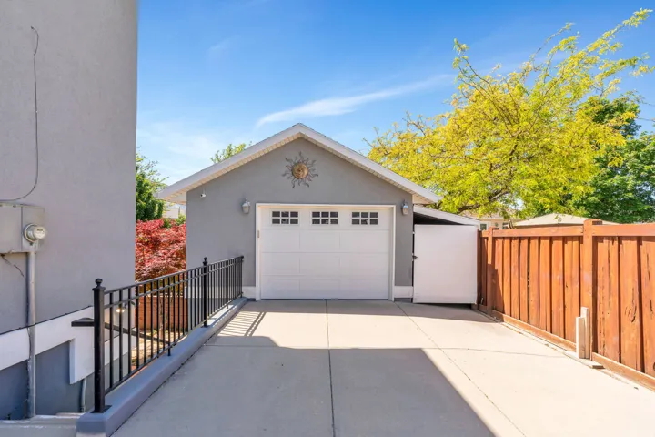 Detached garage with a white panel door and clear transom windows