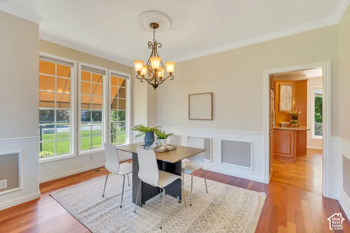Formal dining area featuring rich wood-finish flooring