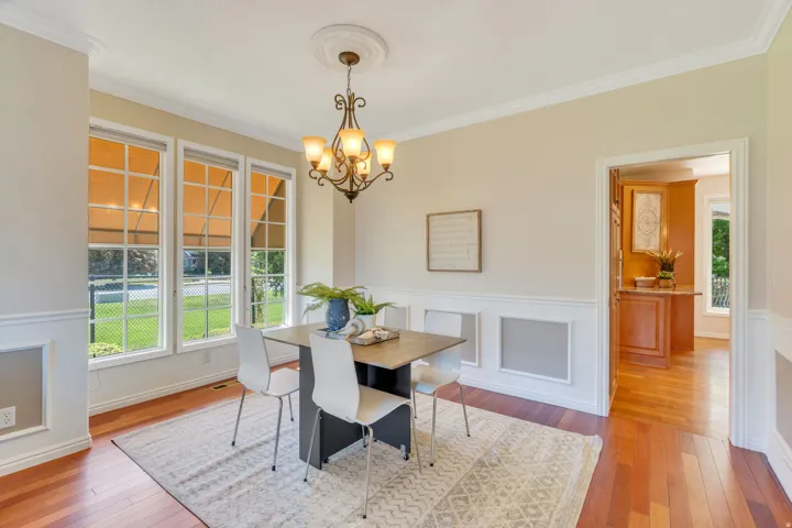 Formal dining area featuring rich wood-finish flooring