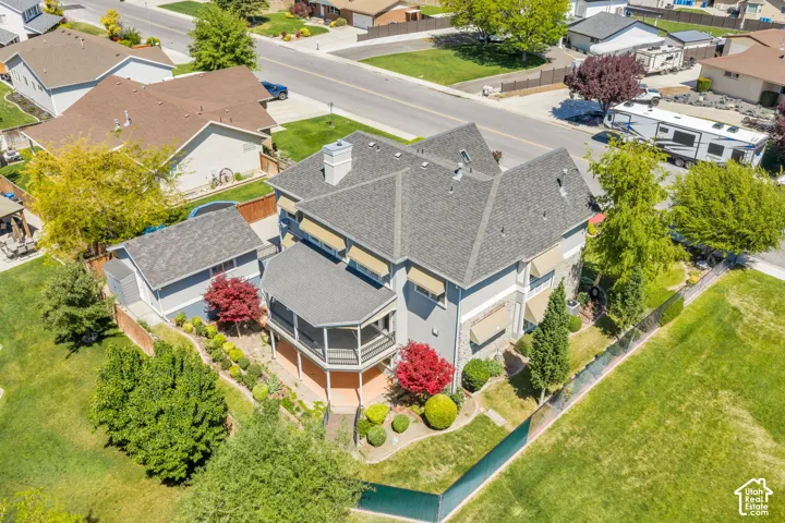Two-story residence featuring a gray exterior, stone accents, and a multi-pitch roof