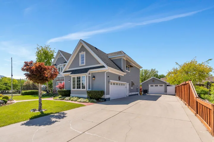 Gray stucco exterior with white trim and a two-car garage