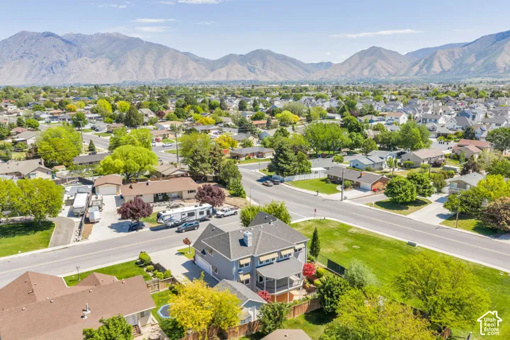 Suburban neighborhood with mature trees and mountain backdrop