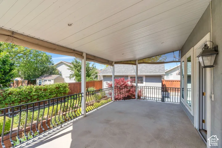 Covered patio featuring concrete flooring and a white paneled ceiling with recessed lighting