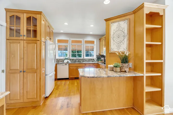 Kitchen featuring light wood cabinetry and wood-finish flooring