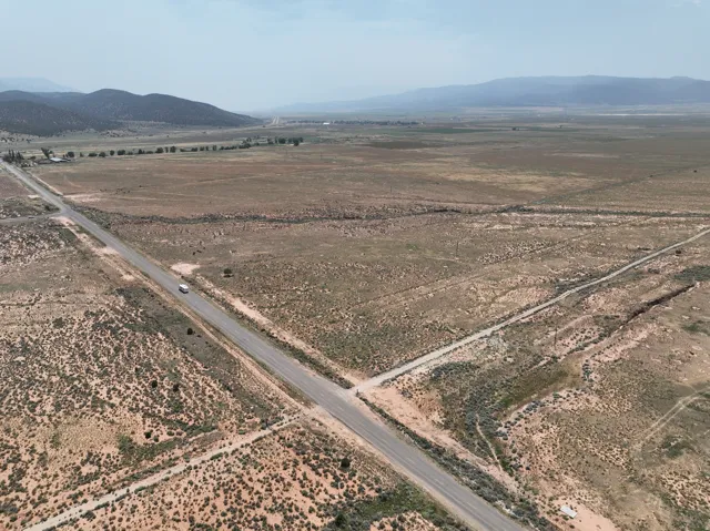 View of rural area featuring a mountain backdrop and a desert landscape