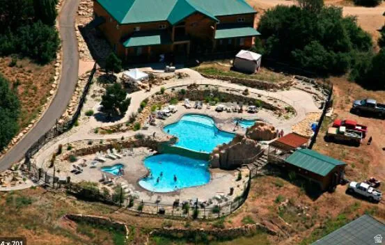 Multi-tiered swimming pool complex featuring a primary pool, a smaller secondary pool, and an integrated spa