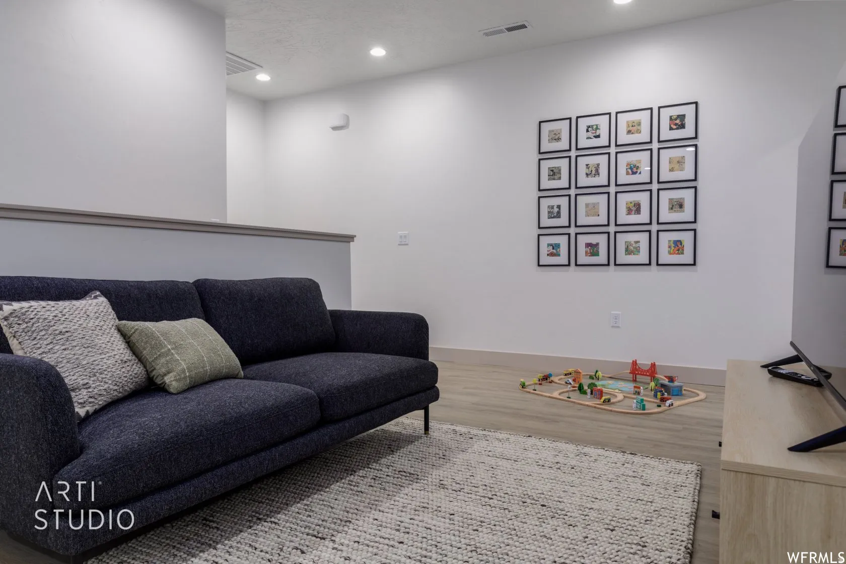 Open-concept area featuring light wood-finish flooring and recessed lighting
