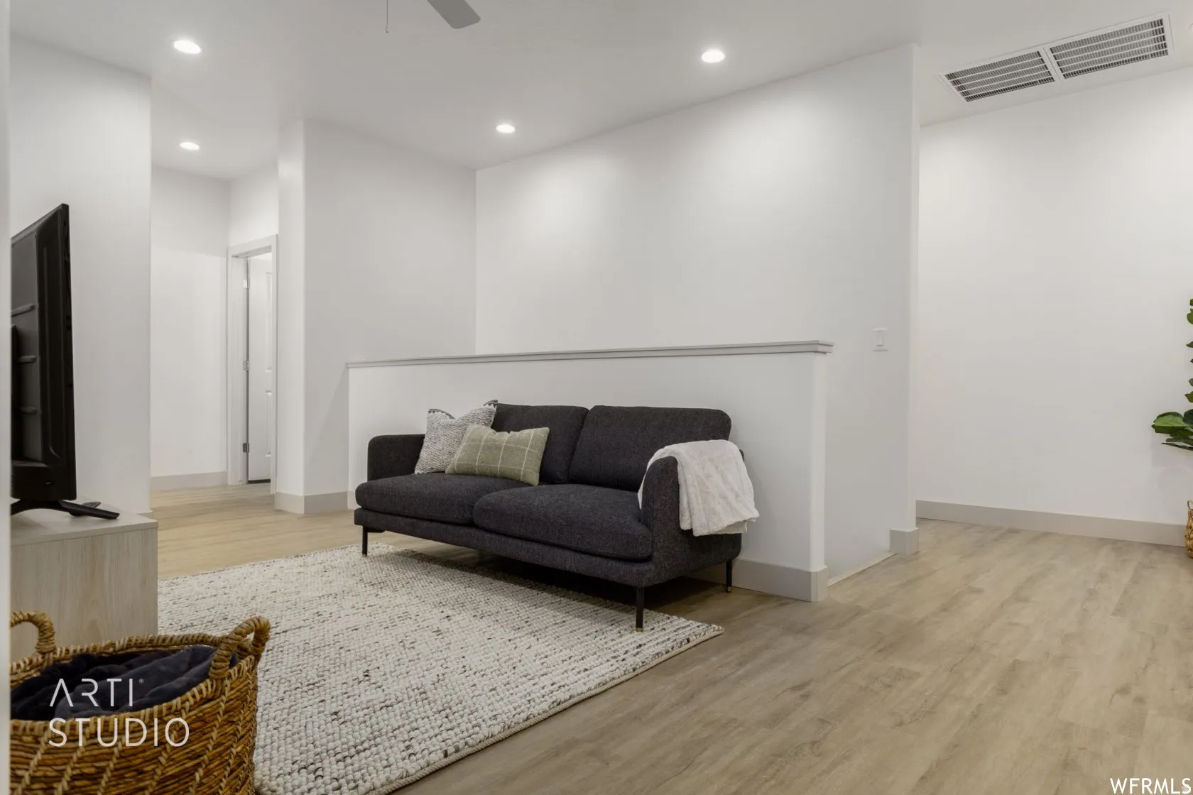 Open-concept bonus room featuring light wood-finish flooring, recessed lighting, and a neutral color palette