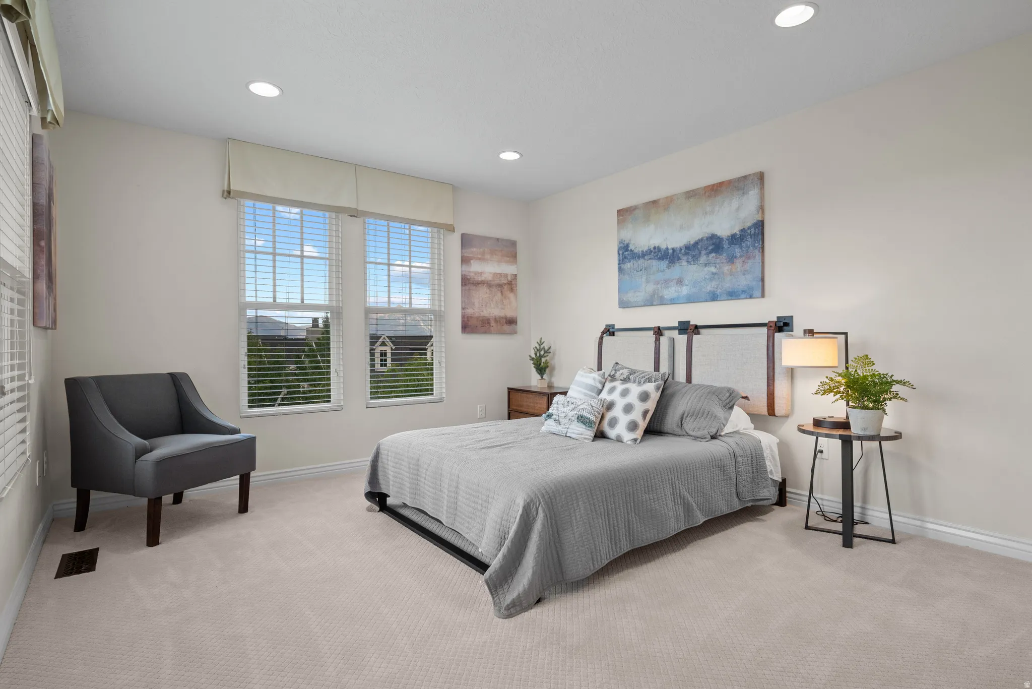 Neutral-toned carpet flooring complements the light wall color