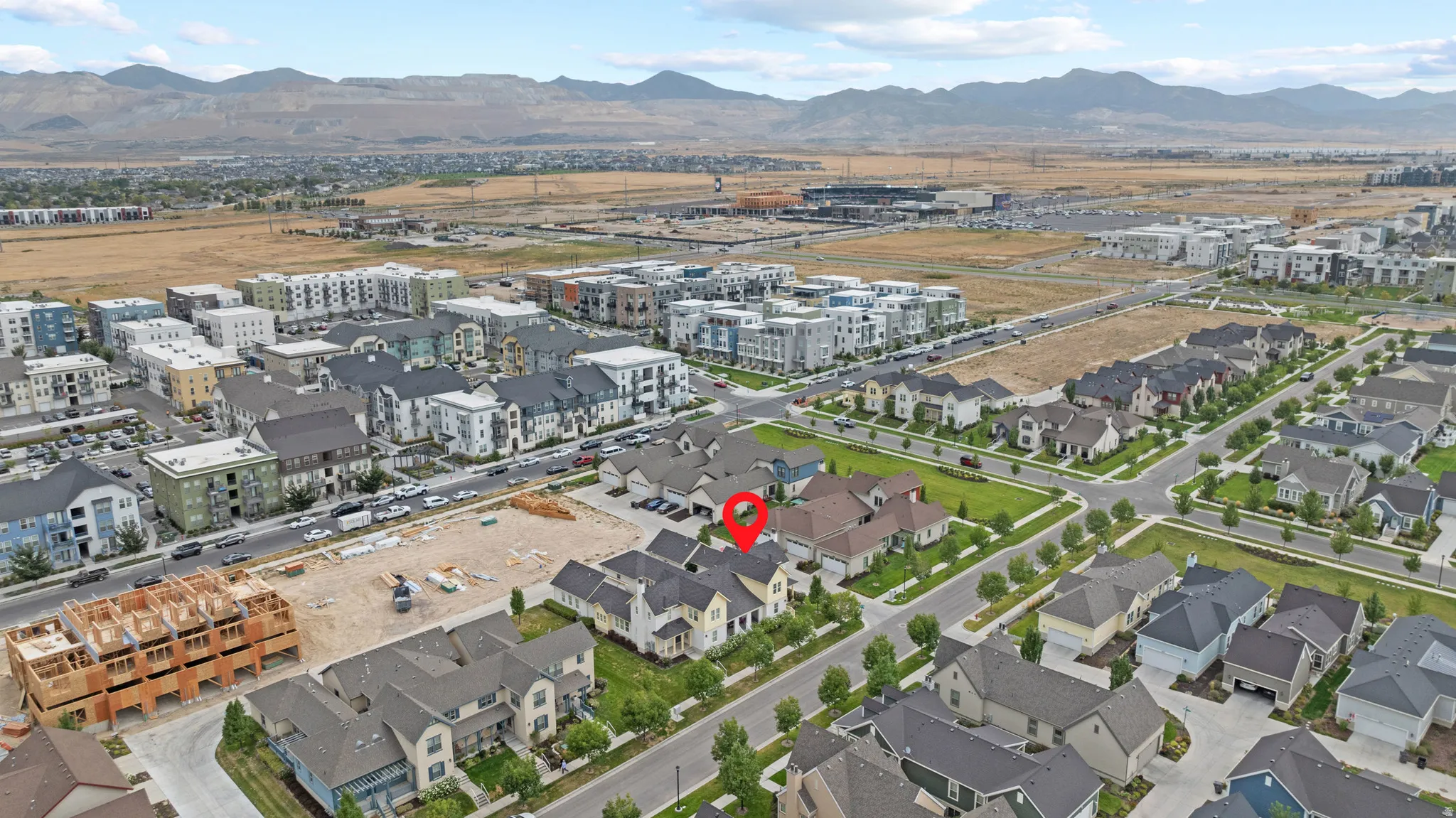 Aerial perspective of a developed residential neighborhood with a variety of housing styles, including single-family homes and multi-story buildings
