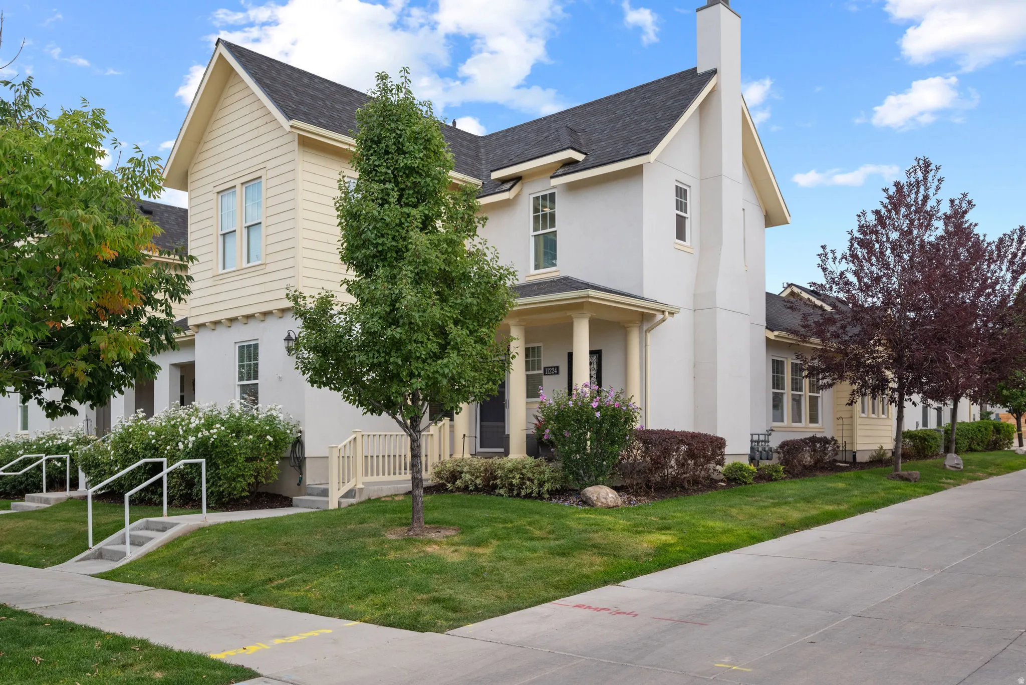 Multi-level residence featuring a mix of horizontal siding and stucco exterior finishes