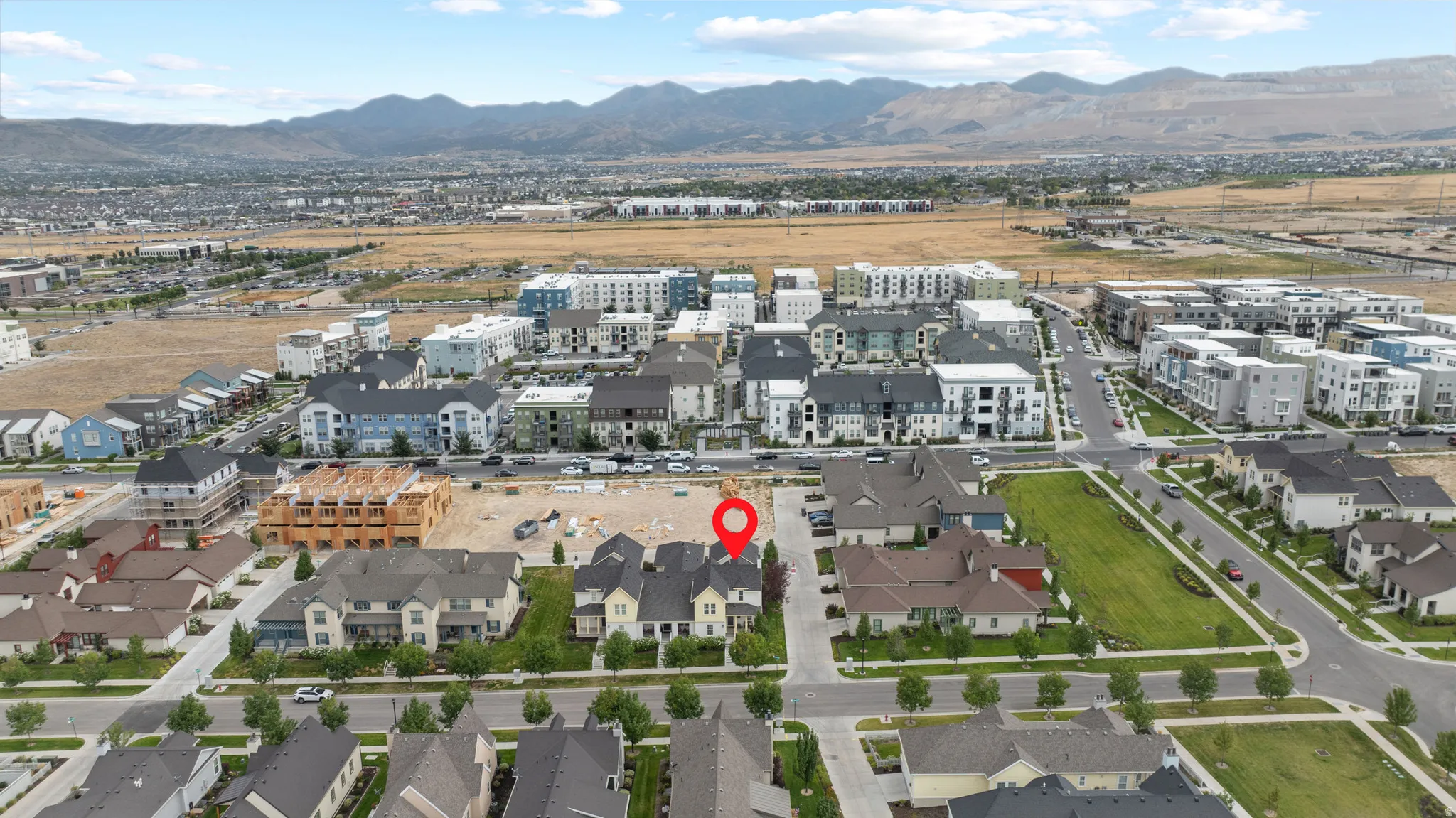 Aerial perspective showcasing a residential development with mountain backdrop