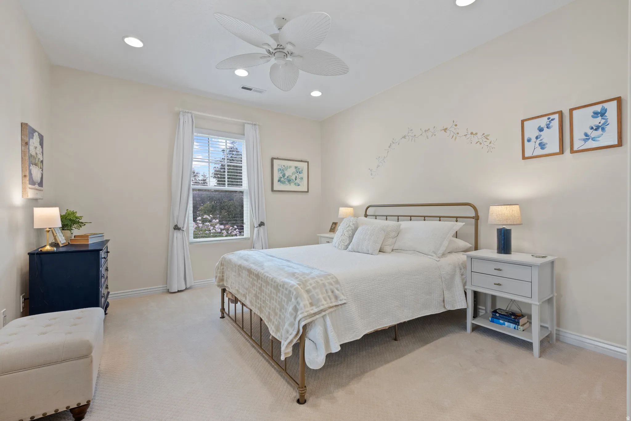 Recessed ceiling lighting, ceiling fan, and window with blinds and drapes
