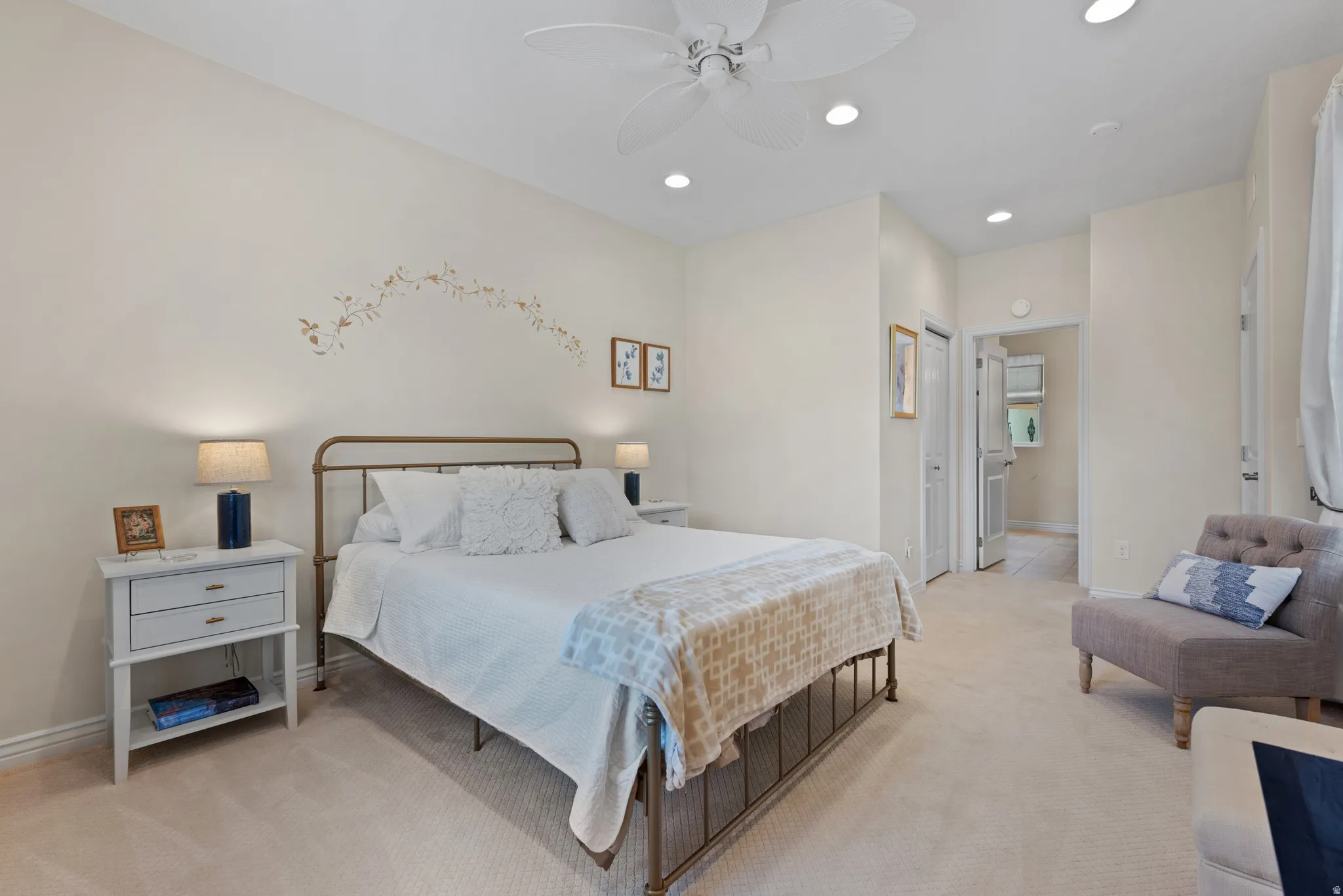 Carpeted room featuring a ceiling fan with integrated lighting, recessed ceiling lights, and light-toned wall finishes