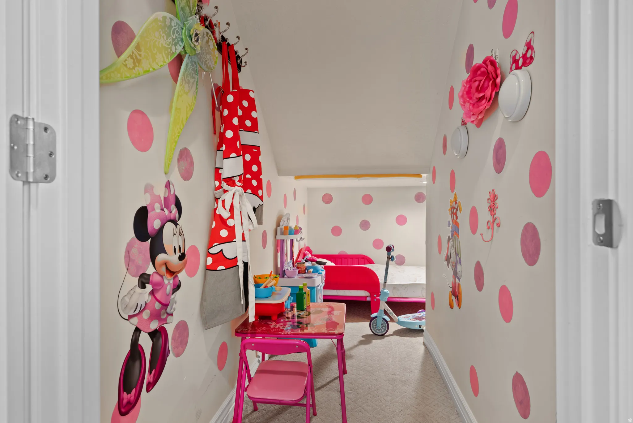 Hallway featuring light-colored walls with pink polka dot detailing