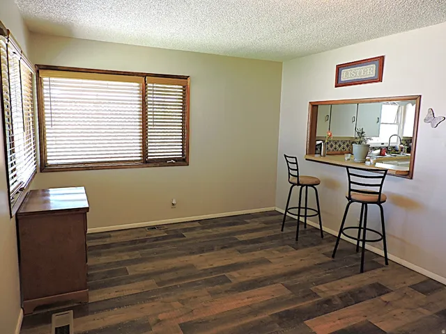 Wood-finish flooring throughout, featuring a pass-through window.