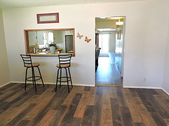 Interior featuring wood-finish flooring, a kitchen pass-through.