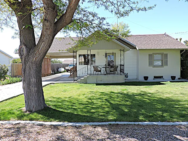 Front exterior with a landscaped front yard and established trees