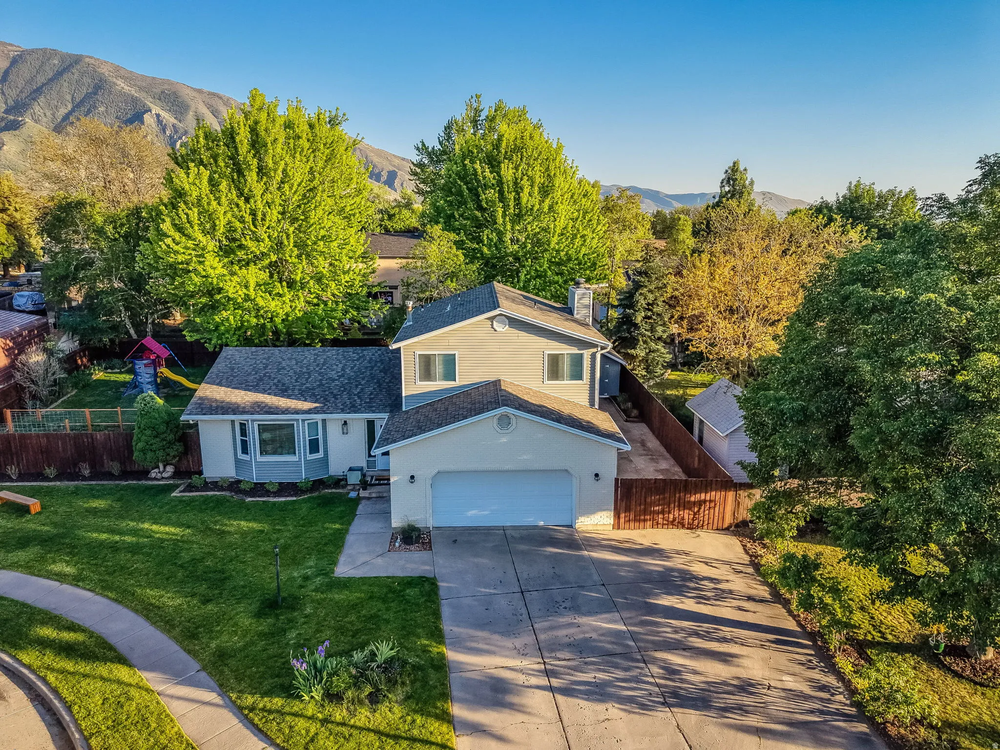 Two-story residence with an attached garage and a concrete driveway